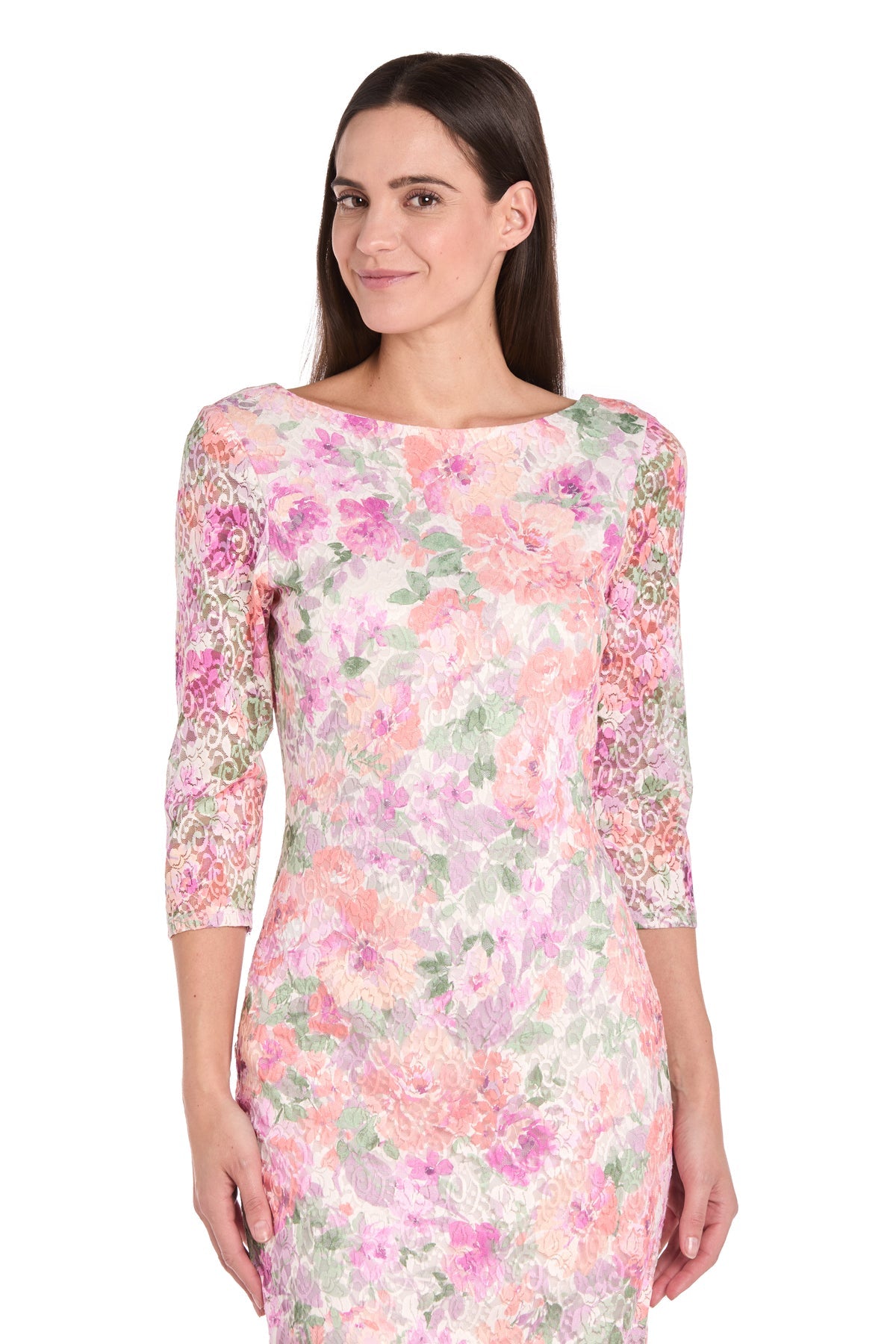 A woman models the R&M Richards 4075 Knee-Length Blossom Party Dress, featuring a floral lace pattern and three-quarter lace sleeves, against a white background.
